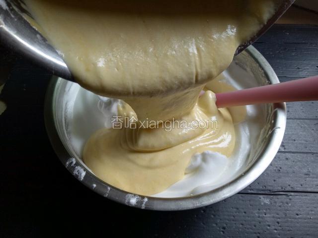 将翻拌好的蛋糊加入蛋白盆中，用橡皮刮刀快速翻拌均匀。