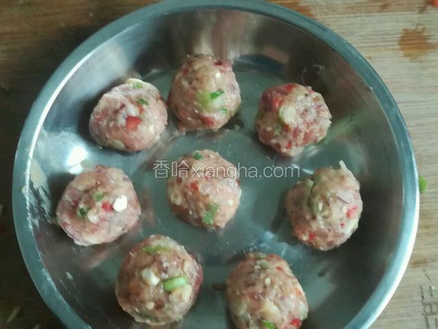 先做几个肉丸，等汤滚以后，避免要煮好长时间肉丸会老。抓一把肉泥，来回摔打几次再搓圆，这样丸子比较紧实。
