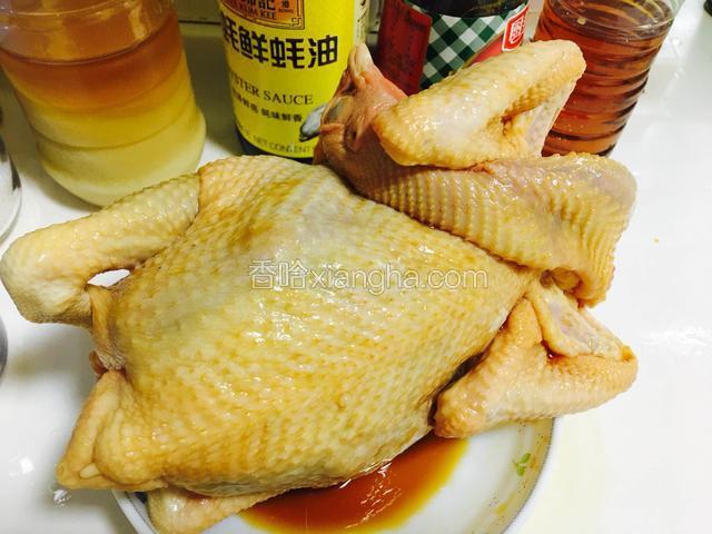 均匀地涂抹在鸡身上和鸡肚，鸡肚里倒入少许腌汁，用牙签封住鸡尾巴。
