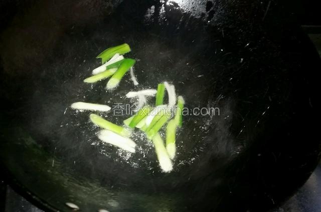 清洗干净炒锅，锅烧热时加入适量的花生油，由于芥兰比较吃油，下的稍多一些，油热时加入青蒜头，煸炒出香味时再加入芥兰翻炒片刻。