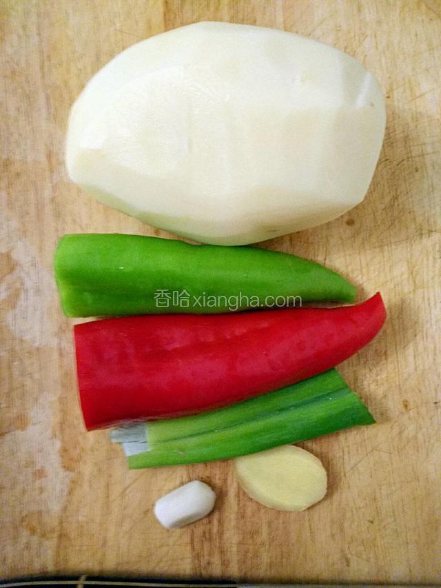 准备食材。削皮土豆一个，红椒绿椒各半个，葱一节，姜一片，蒜一颗。