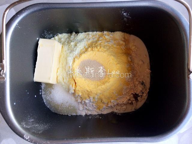 依照食材表按“先液体后固体”的顺序将主料放入面包机搅拌桶里（白糖和盐对角放，酵母放面粉顶端剖出的小坑中）；