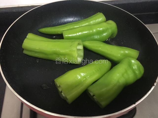 将尖椒放入锅中煎至。