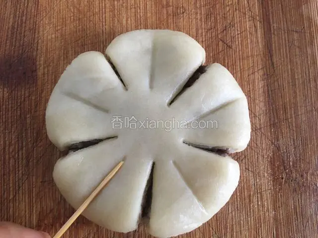 左手拿面饼，右手大拇指和食指将切开口捏出弧度，所谓整形，这一步很关键，整形的好坏直接影响梅花酥的外观（因为是双手操作不好拍照，这一步省略，大家也可利用勺子或者筷子进行整形，总之，要整出的梅花的造型哦…），然后用牙签在每片花瓣上轻轻按出纹路