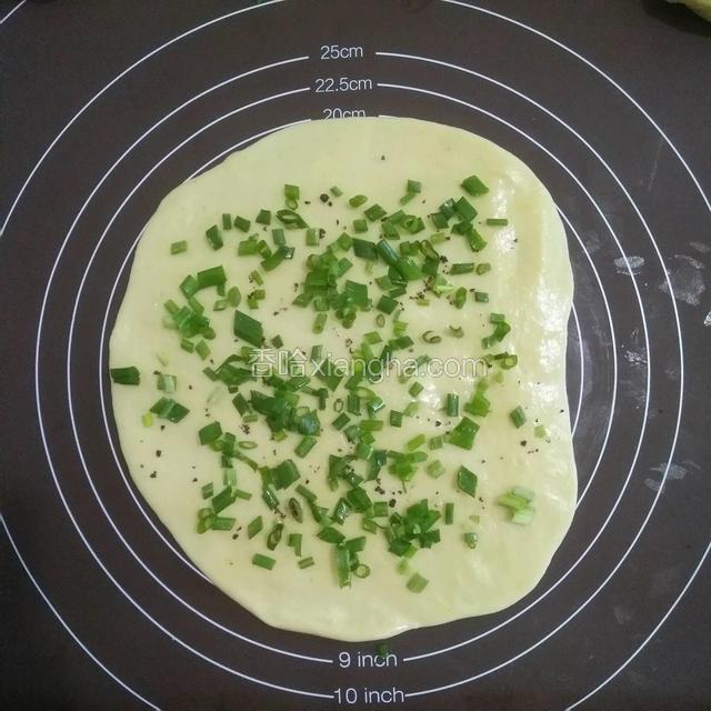 用擀面杖擀薄，抹上少许油，撒上少许椒盐，葱花，从上往下卷