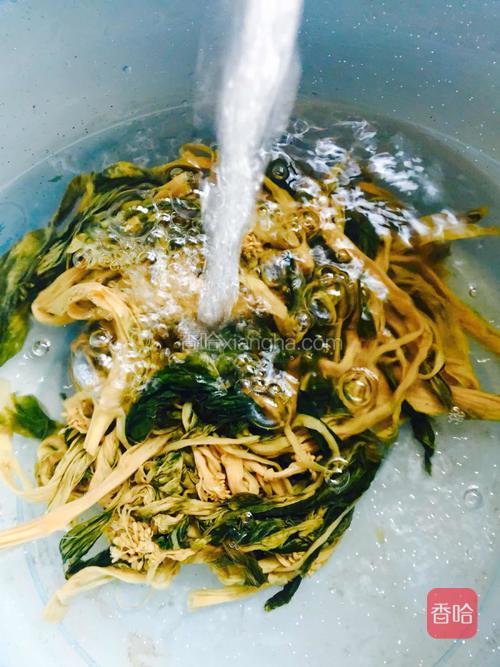 把梅菜干冲洗干净。