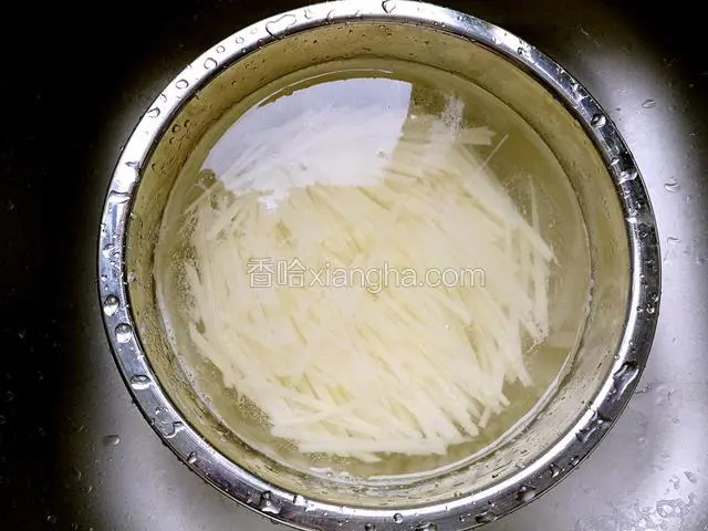 用清水将土豆丝泡去淀粉。(这样炒出来的土豆丝清爽不粘)。