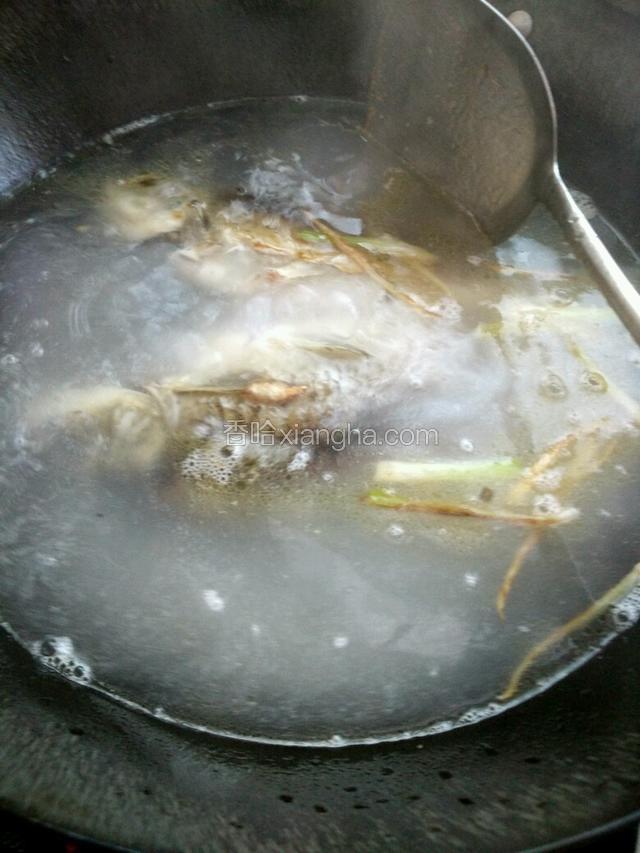 闻到姜葱香味后注入足够的清水烧开后，将煎好的鱼和米浆倒入锅中