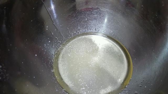 白砂糖倒入玉米油里，搅拌融化。