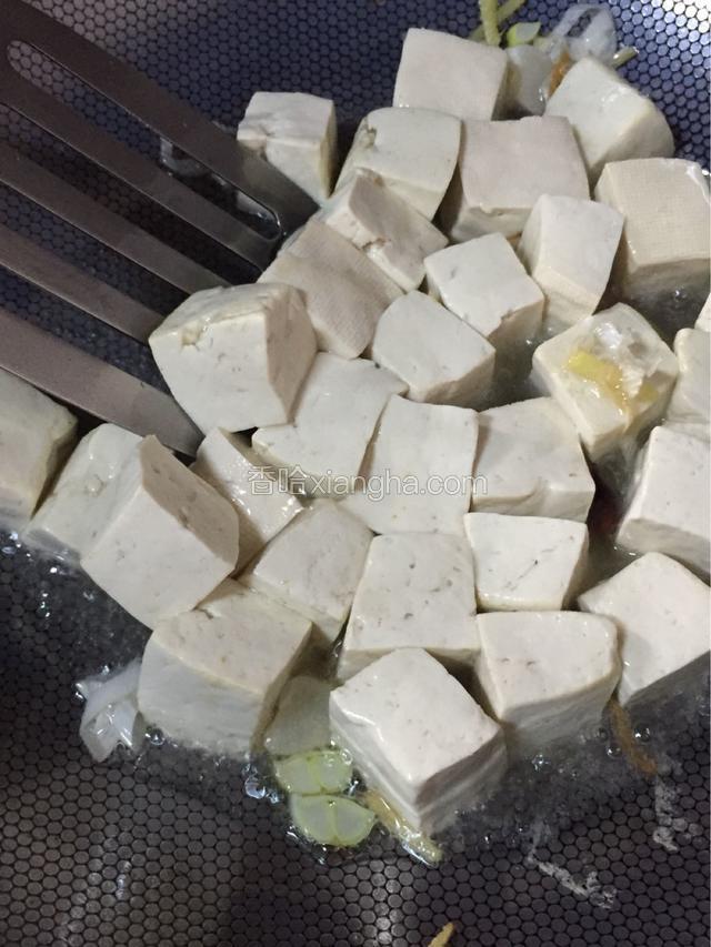 倒入豆腐 放入料酒一小勺翻炒均匀