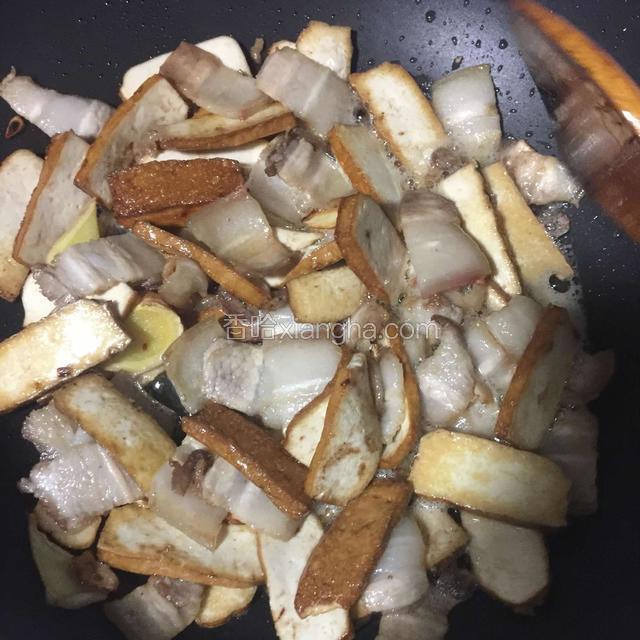 热锅倒少许油煸香姜蒜倒入五花肉煸炒变色再倒入香干、豆瓣酱翻炒片刻