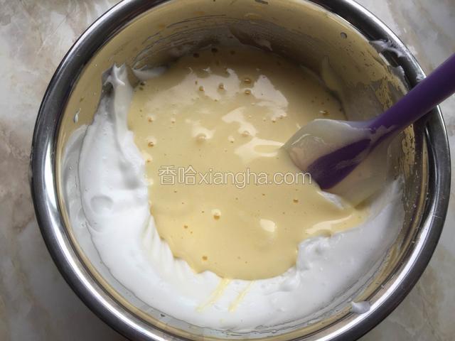 再把蛋黄糊倒入剩下的蛋白中继续翻拌均匀。