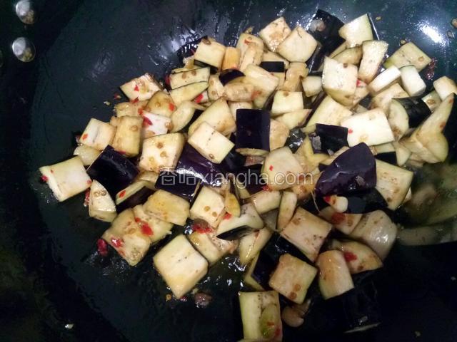下入茄子炒匀，再加适量清水至茄子烧熟。