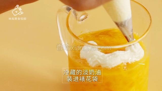 冷藏的淡奶油装进裱花袋并涂抹在芒果汁上