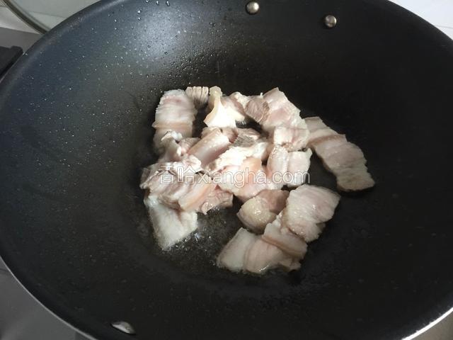 放入五花肉小火慢煎至出油。