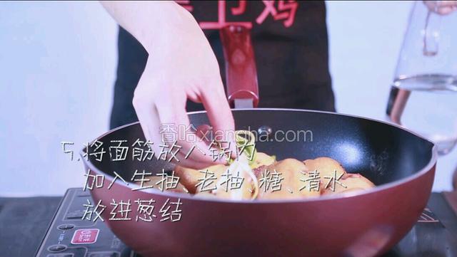 取一口锅，将面筋放入锅内，加入生抽、老抽、糖、和适量的清水，然后放入葱结。
