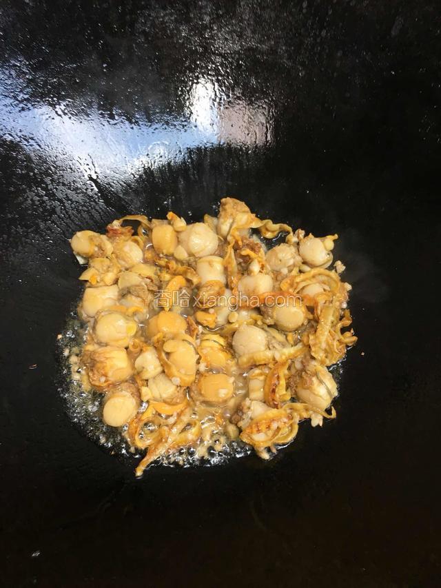 热锅倒入适量纯正花生油烧热后撒入一小把蒜蓉爆香后倒入小扇贝肉爆炒片刻
