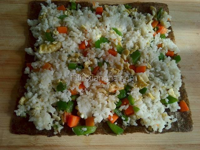 炒米饭平铺放在紫菜上。