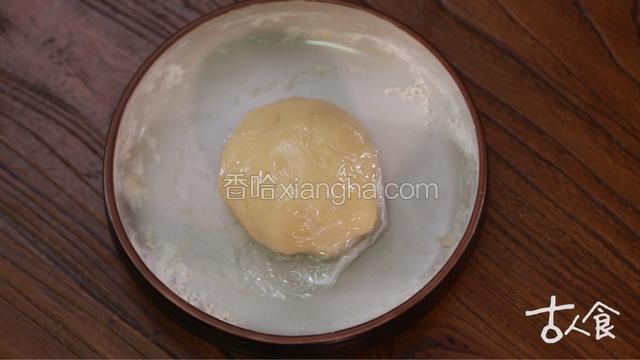 
制作油皮，
面粉、糖粉、猪油略拌，再将三十五克水分次加入混合均匀，装入保鲜袋松弛一小时