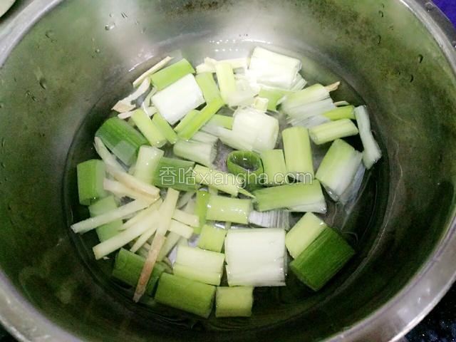 把葱姜放到一个不锈钢碗里，再放入适量的水，开中小火煮