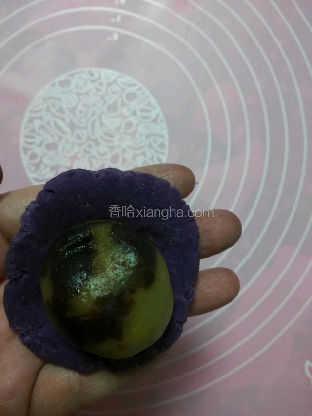 紫薯圆子压成皮，放上馅料，用虎口扣起来，再慢慢把紫薯包住馅料