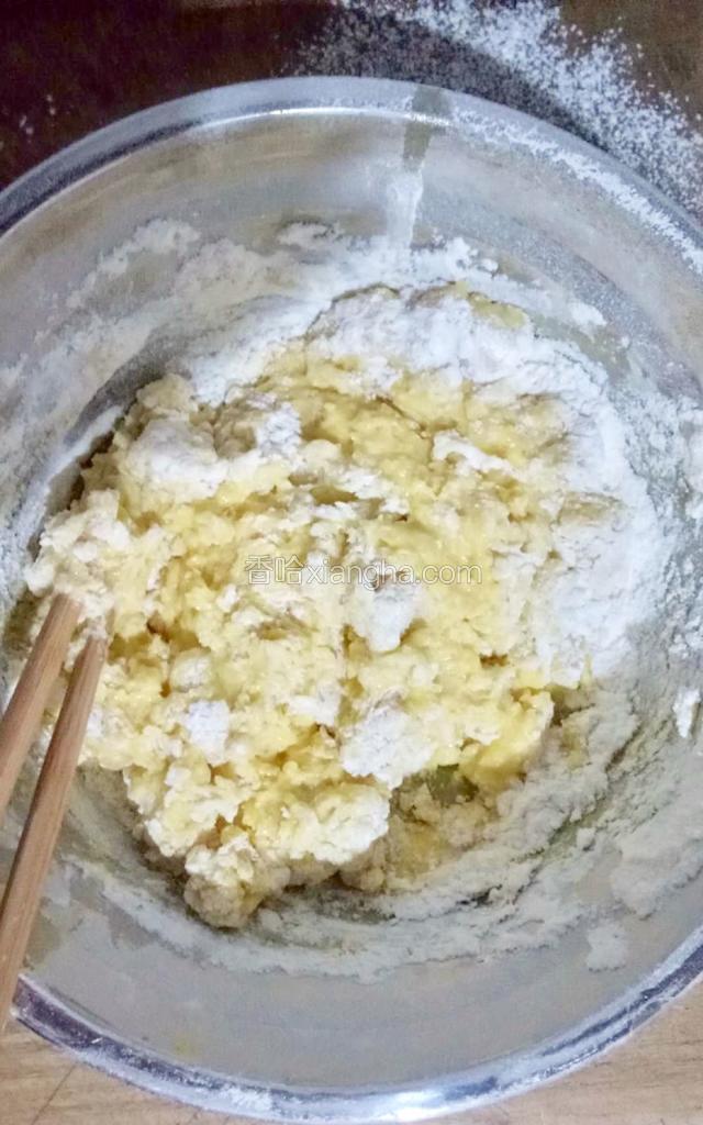 再加入两个鸡蛋并继续搅拌均匀，如果面粉很干的话期间加入一点点清水，继续搅拌至干粉状态。
