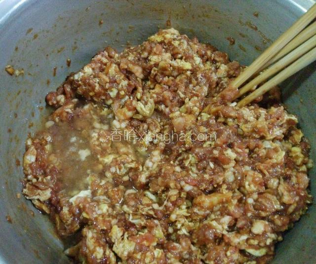 肉馅拌匀开始第一次加花椒水，继续搅拌。