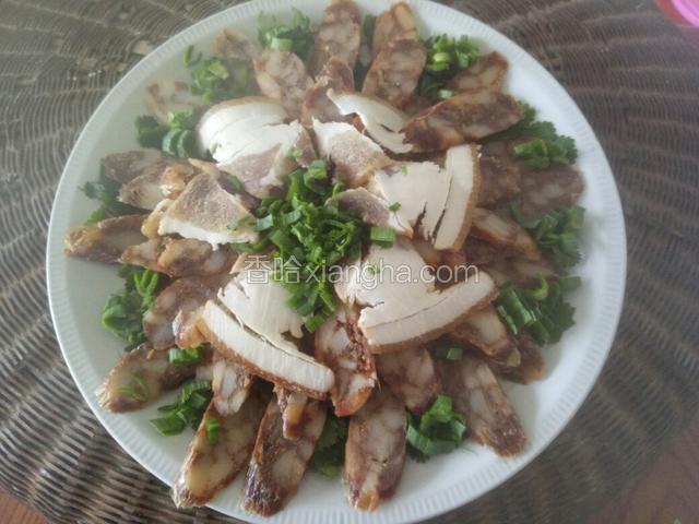 先把香菜.蒜叶.腊肠.腊肉切好备用，然后再菜盘底部铺好香菜，再把香肠按照自己喜欢的样式摆放好，我这里摆的是菊花的样式，最上层放几片腊肉，中间放上蒜叶，这样就装好盘了。