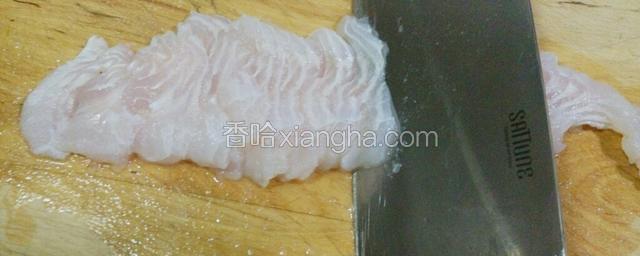 用刀斜刀切片，左手按住鱼片，右手用刀斜切。自己拍照不方便，没有全图。