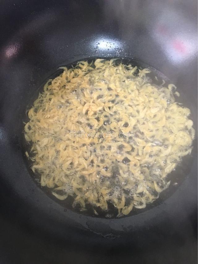 锅下入油烧至三成热时倒入虾皮爆香