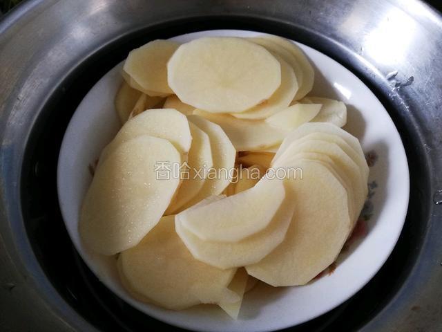 准备好食材，将土豆切成片上锅蒸熟。