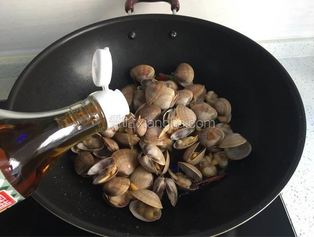 倒入黄蚬子，淋料酒、生抽翻炒。