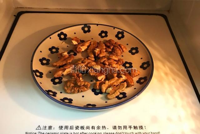 把核桃放入微波炉中加热一分半钟，放凉后切成小碎块。