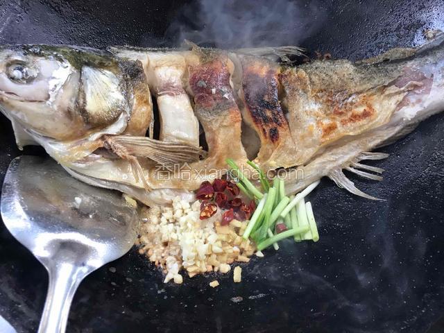 把锅歪一边，放入姜末、蒜末、干辣椒和葱段爆香
