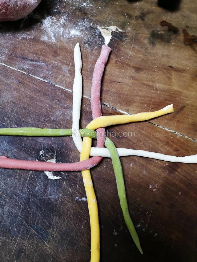 如图顺时针依次将黄，绿，红，白四根不同颜色的面条压在与它平行的面条上。