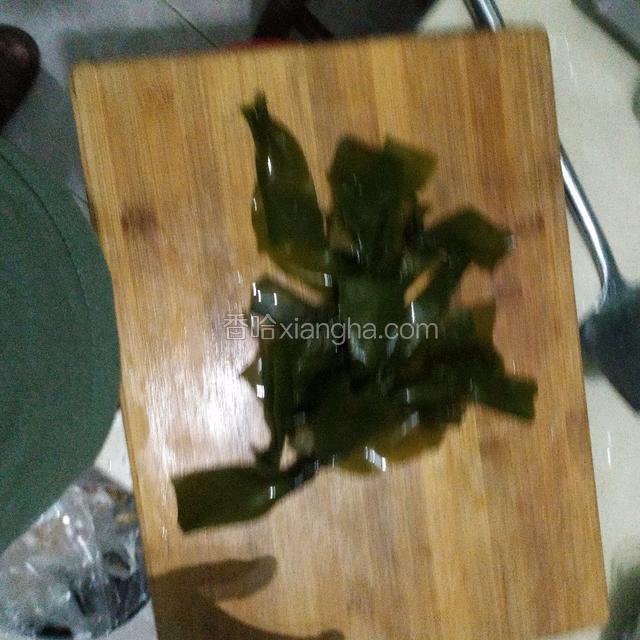 海带结用刀把中间的结给切开，因为不切开的话，结里面会有沙子，然后洗干净。放在碗里备用。