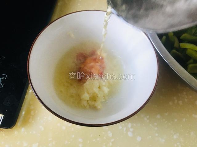 碗中放入蒜蓉、小米辣、盐、白糖，浇上热花椒油，呲出蒜香味。